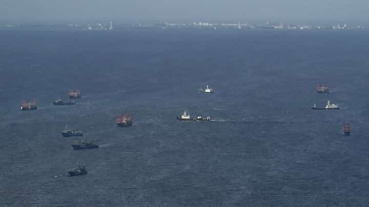 (FILES) This aerial photo shows part of the Subi Reef and Chinese vessels identified by the Philippines as "maritime militia" near Thitu Island in the disputed South China Sea on 1 December 2023.