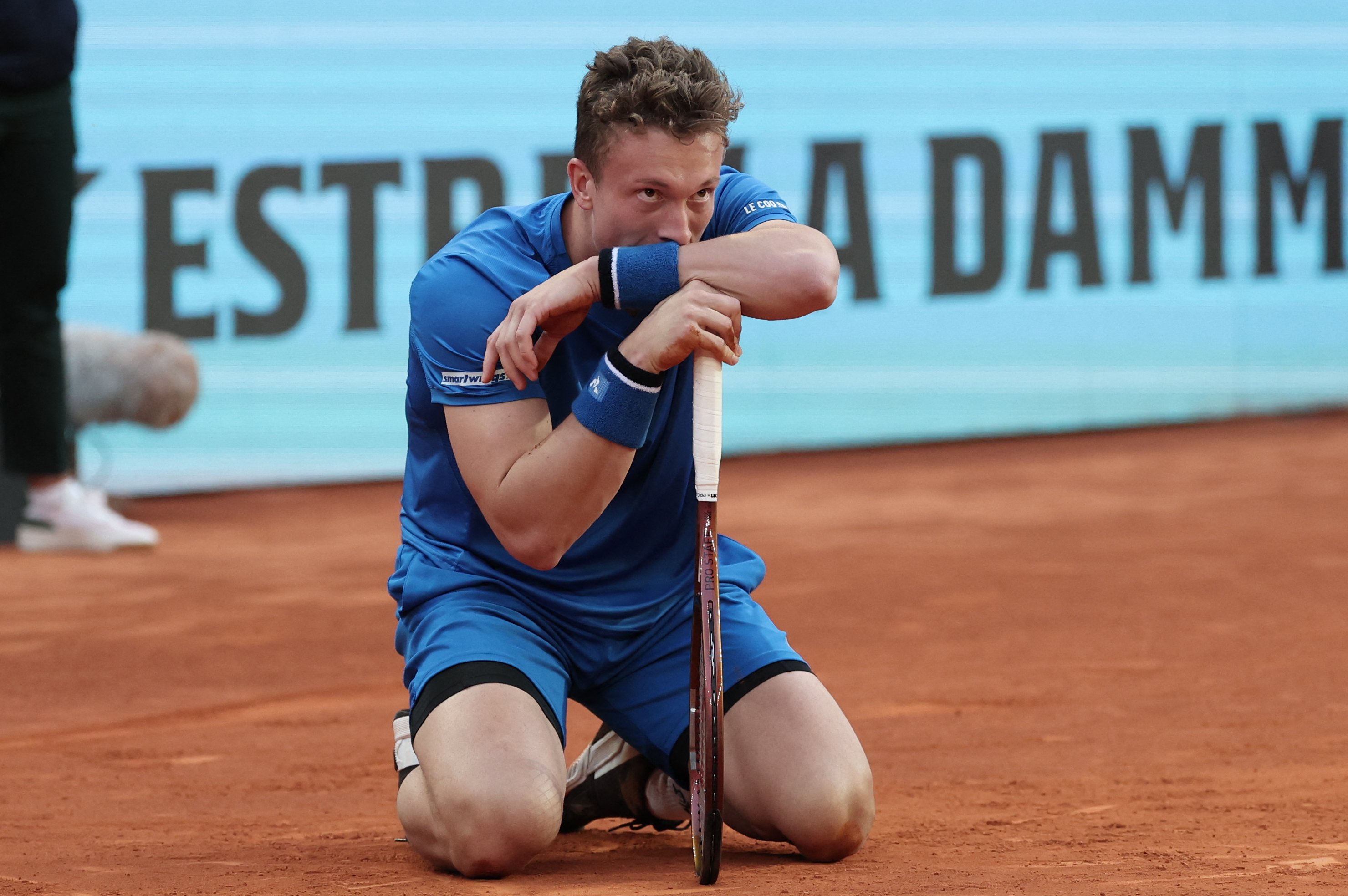 JIRI Lehecka kneels on the court before retiring due to a back problem during his semifinal clash with Felix Auger-Aliassime in the Madrid Open.