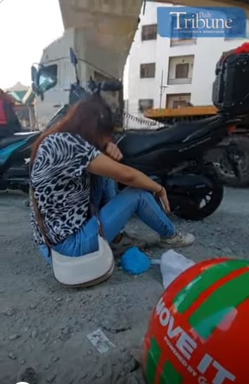 WOMAN SOBBING AFTER MOTORCYCLE TAXI MISHAP