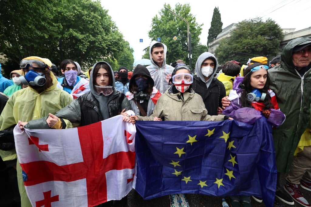 Georgian protesters rally against the controversial "foreign influence" bill in Tbilisi on 14 May 2024. Georgia's parliament on 14 May 2024 adopted a controversial "foreign influence" law that has sparked weeks of mass protests against the measure, denounced as mirroring Russian legislation used to silence dissent. The bill requires non-governmental organizations and media outlets that receive more than 20 percent of their funding from abroad to register as bodies "pursuing the interests of a foreign power."