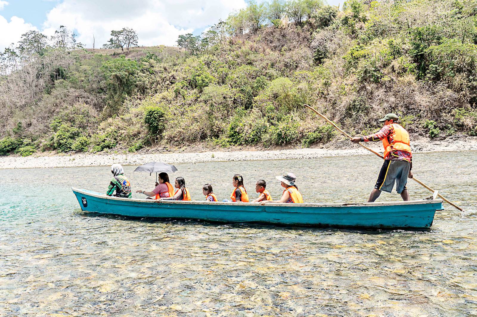 People flock to the Abuan River in Ilagan, Isabela, on Wednesday morning, to cool off from the summer heat.