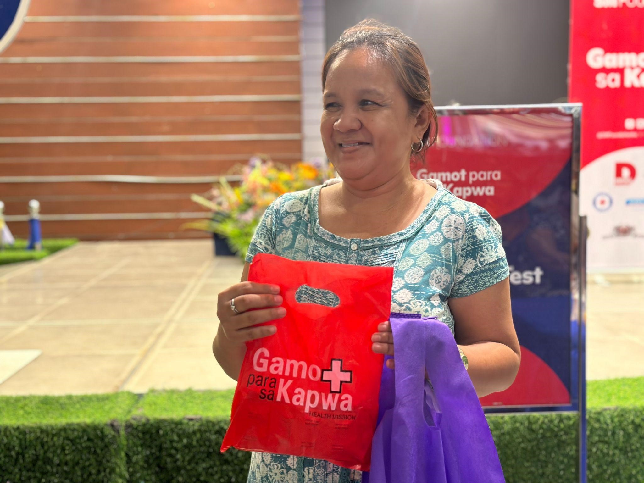 Loida smiles after receiving free medicines from the SM Foundation.