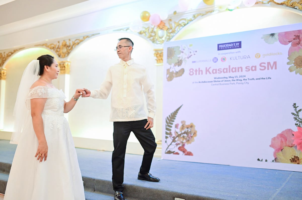 Harold Picar, wearing a barong Tagalog from Kultura, poses with his wife Katrina Rose, with Kultura having provided barong Tagalogs for all 16 grooms.