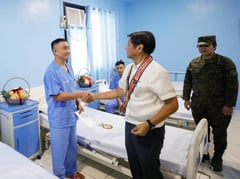 Marcos pins medals to wounded soldiers