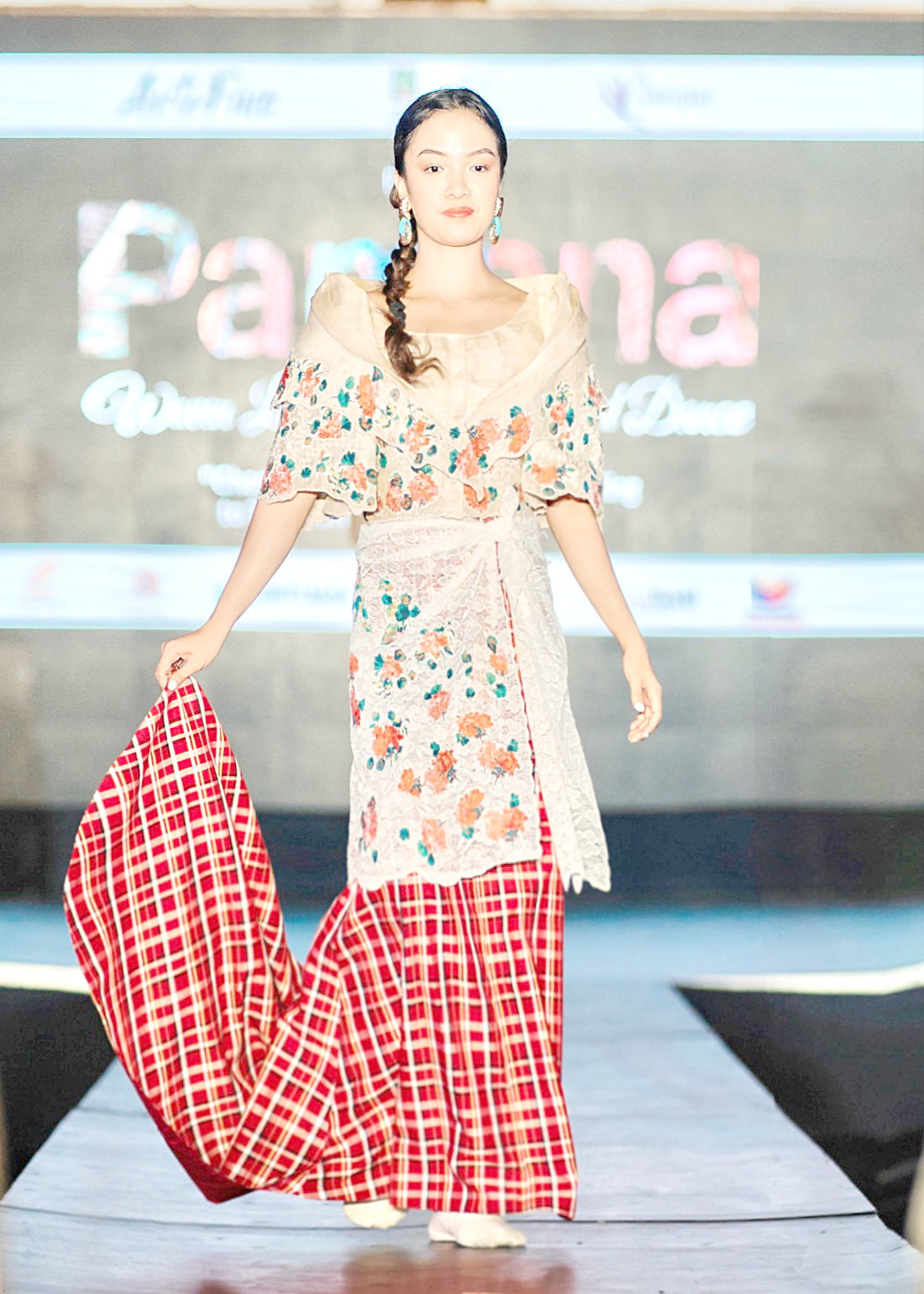 The first Patis creation for Mita Rufino in 1984. Handwoven abaca Baro and Panuelo with machine embroidered tangerine floral appliqués, handwoven checkered Patadyong serpentina in red, blue and yellow, lace tapia adorned with machine embroidered flowers.
