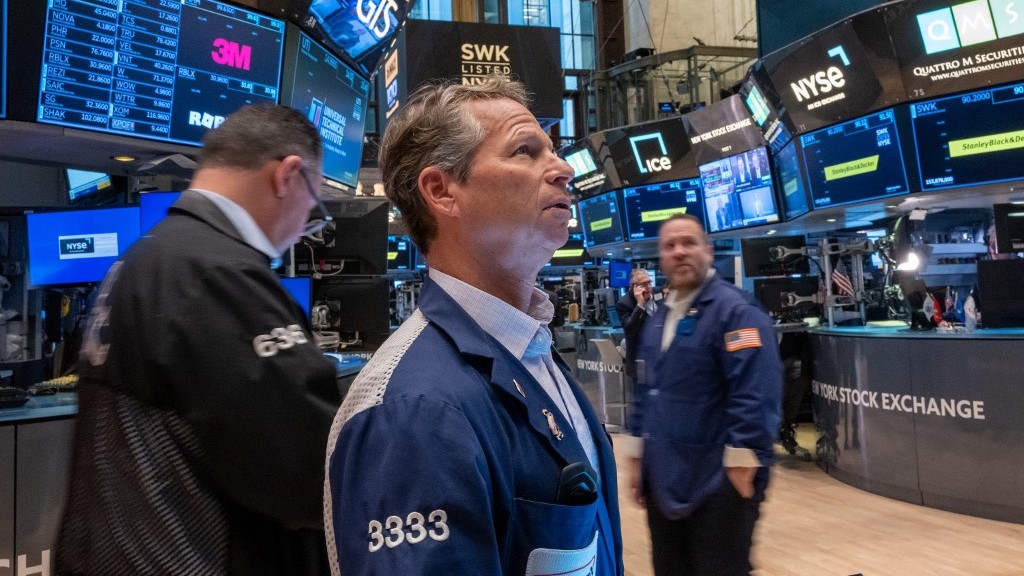 US stocks dip after Dow tops 40,000 for first time