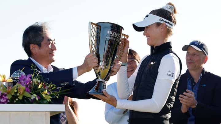 Nelly Korda of the United States is presented with the winner’s trophy after winning the Mizuho Americas Open at Liberty National Golf Club on 19 May 2024 in Jersey City, New Jersey.