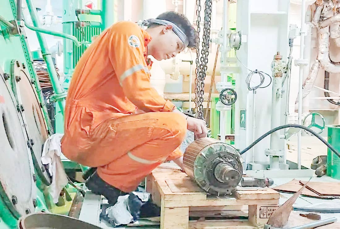A Filipino seafarer is at work aboard a ship of the Middle East Shipping Line.