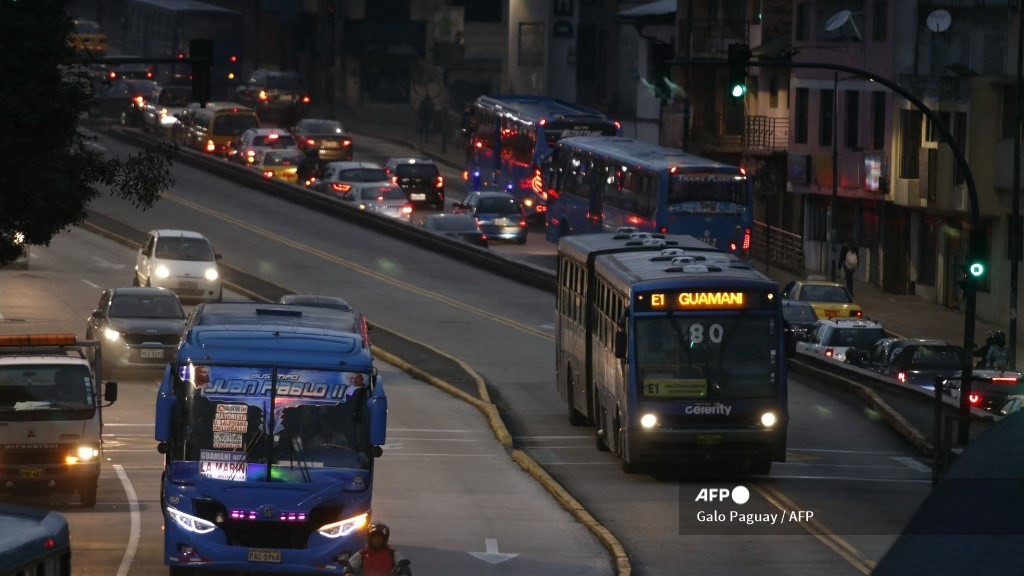 Two buses travel on a main road during a blackout in Quito on 19 June 2024.