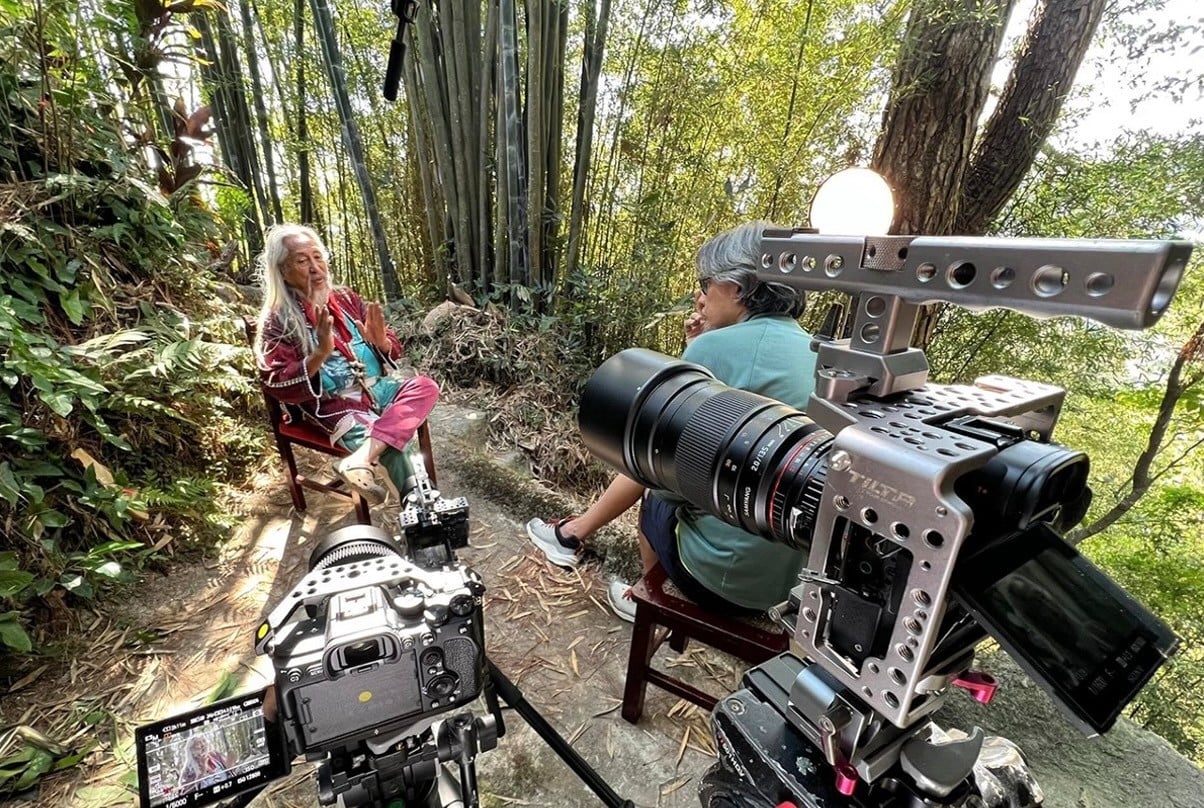 national artist Kidlat Tahimik being interviewed for the documentary by filmmaker Gabriel Malvar.