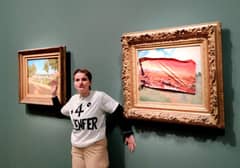 MEMBER of Riposte Alimentaire wearing a T-shirt reading ‘+4o the hell’ posing after covering Claude Monet’s painting ‘Les Coquelicots,’ with a sticker of the same scene in the year 2100, ravaged by flames and drought, at the Orsay Museum in Paris.
