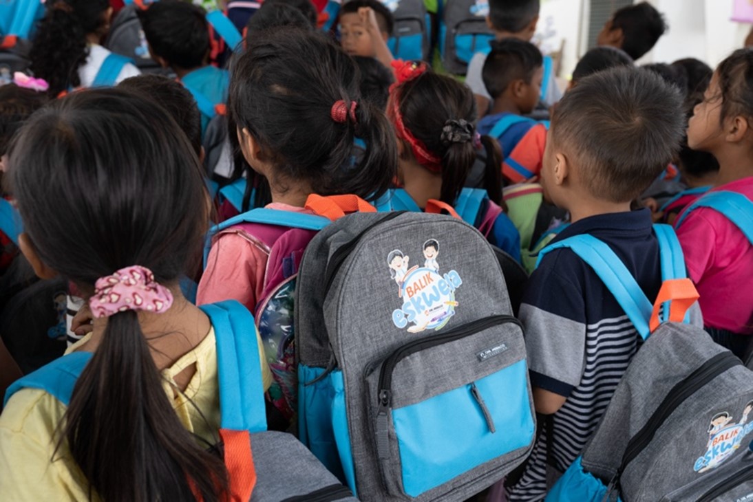 Public school students gear up for the new school year with Balik Eskwela kits.