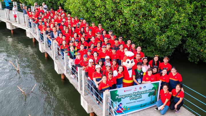 JOLLIBEE employees, with Jollibee mascot, prepare to plant mangrove seedlings at the Bued Mangrove Ecopark in Alaminos, Pangasinan last month.