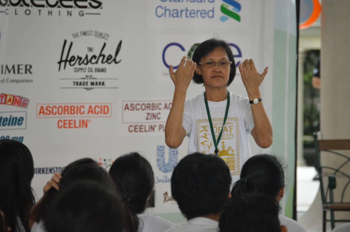 Ma. Teresa Buenaventura interprets for the deaf kids during the For The Kids event.