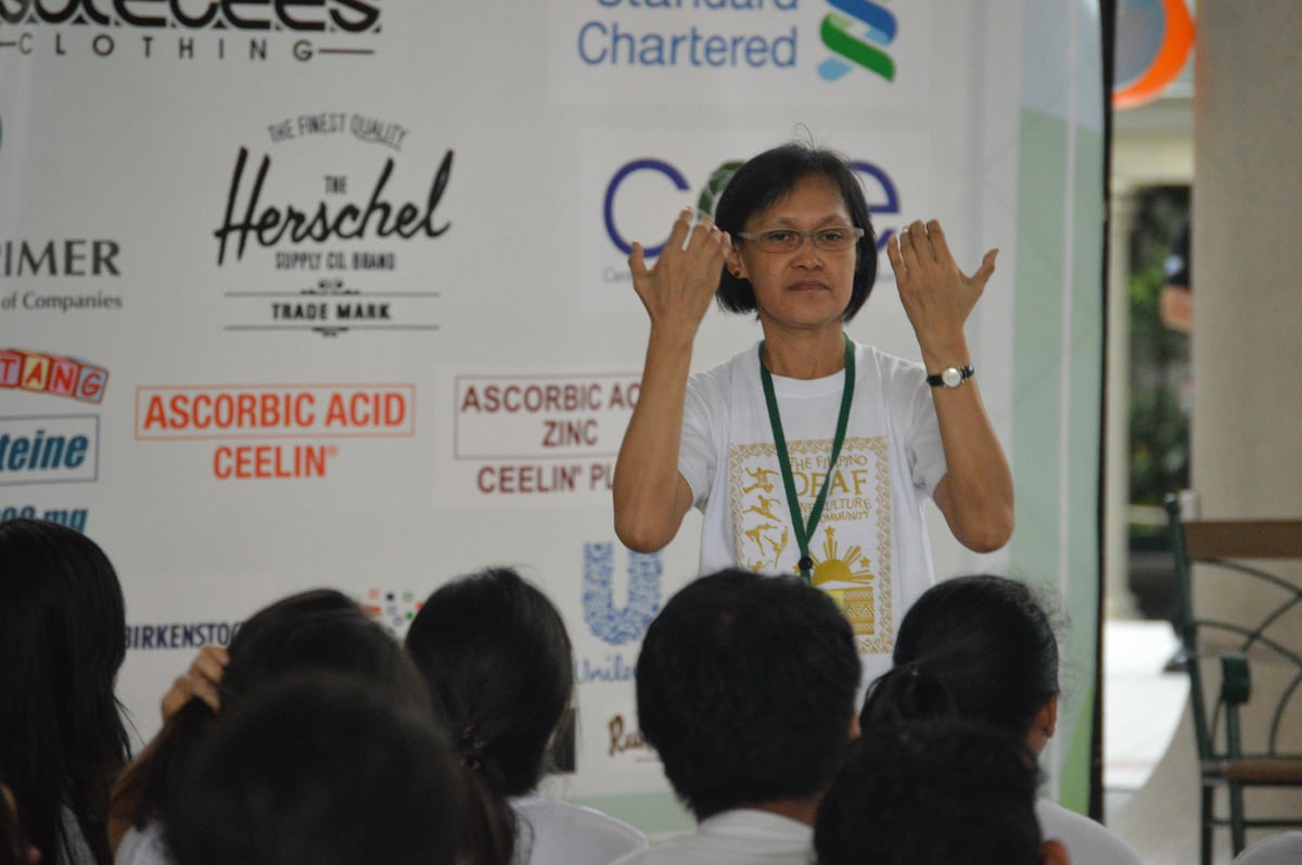 Ma. Teresa Buenaventura interprets for the deaf kids during the For The Kids event.