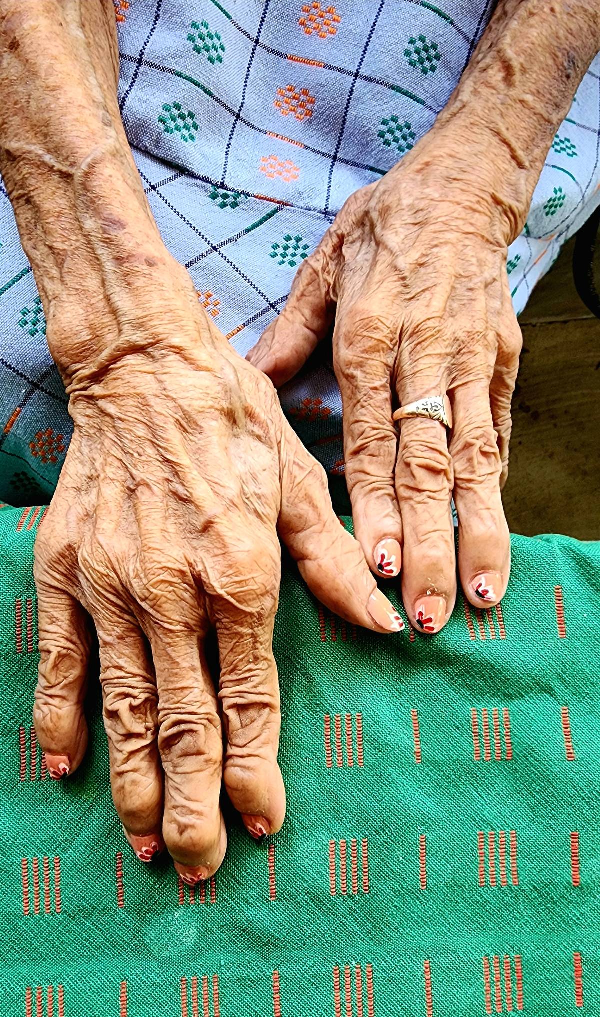 The hands of Magdalena Gamayo, which have woven textiles and upheld tradition, now its fingernails painted with design inspired by a textile pattern inubon a sabong.