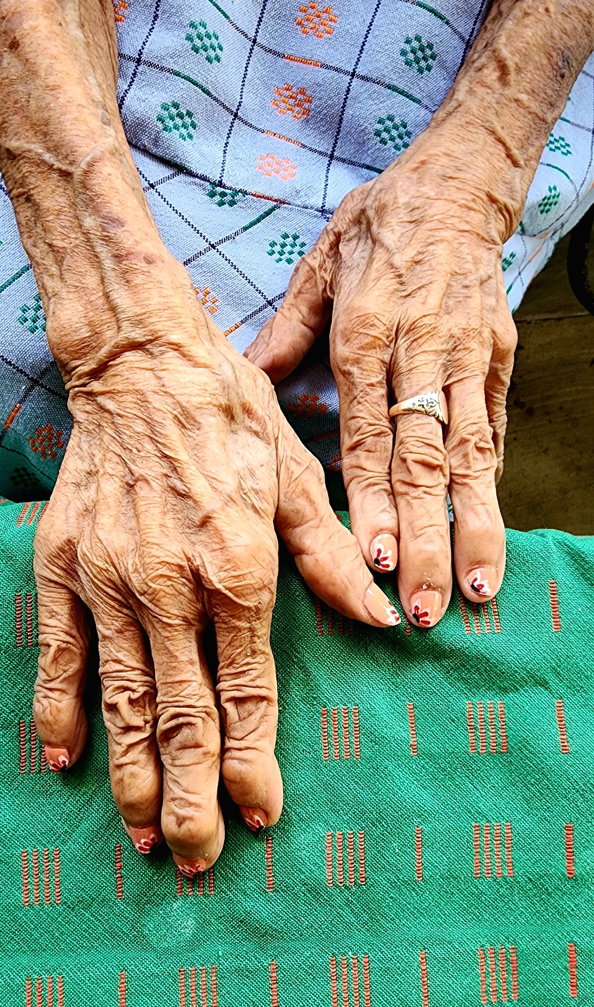 The hands of Magdalena Gamayo, which have woven textiles and upheld tradition, now its fingernails painted with design inspired by a textile pattern inubon a sabong.