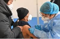 (FILES) An elderly man receives a Covid-19 vaccine.