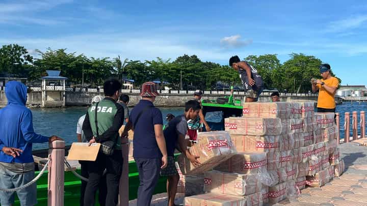 Police check on the smuggled cigarettes seized by authorities at the Naval Station Romulo Espaldon in Zamboanga City.