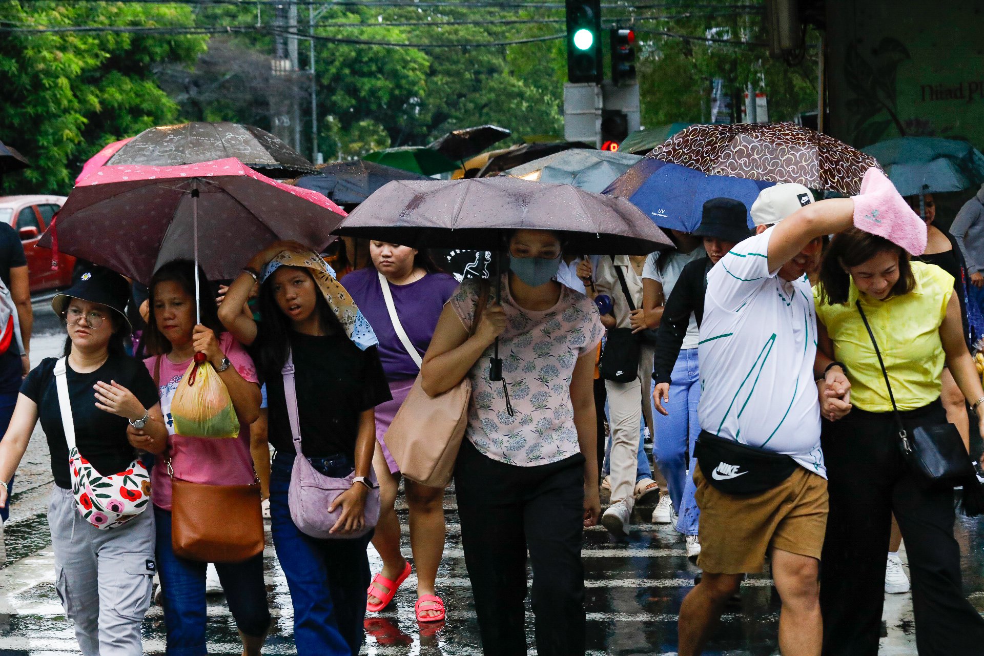 Motorists and pedestrians experienced heavy rain along UN Avenue in Manila on June 21, 2024. PAGASA said that some parts of Luzon may experience heavy rainfall due to localized thunderstorms.