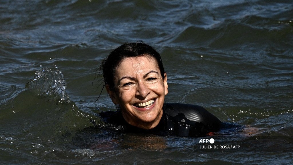 Paris Mayor Anne Hidalgo swims in the Seine, in Paris on 17 July 2024, to demonstrate that the river is clean enough to host the outdoor swimming events at the Paris Olympics later this month. Despite an investment of 1.4 billion euros ($1.5 billion) to prevent sewage leaks into the waterway, the Seine has been causing suspense in the run-up to the opening of the Paris Games on July 26 after repeatedly failing water quality tests. But since the beginning of July, with heavy rains finally giving way to sunnier weather, samples have shown the river to be ready for the open-water swimming and triathlon -- and for 65-year-old Hidalgo.