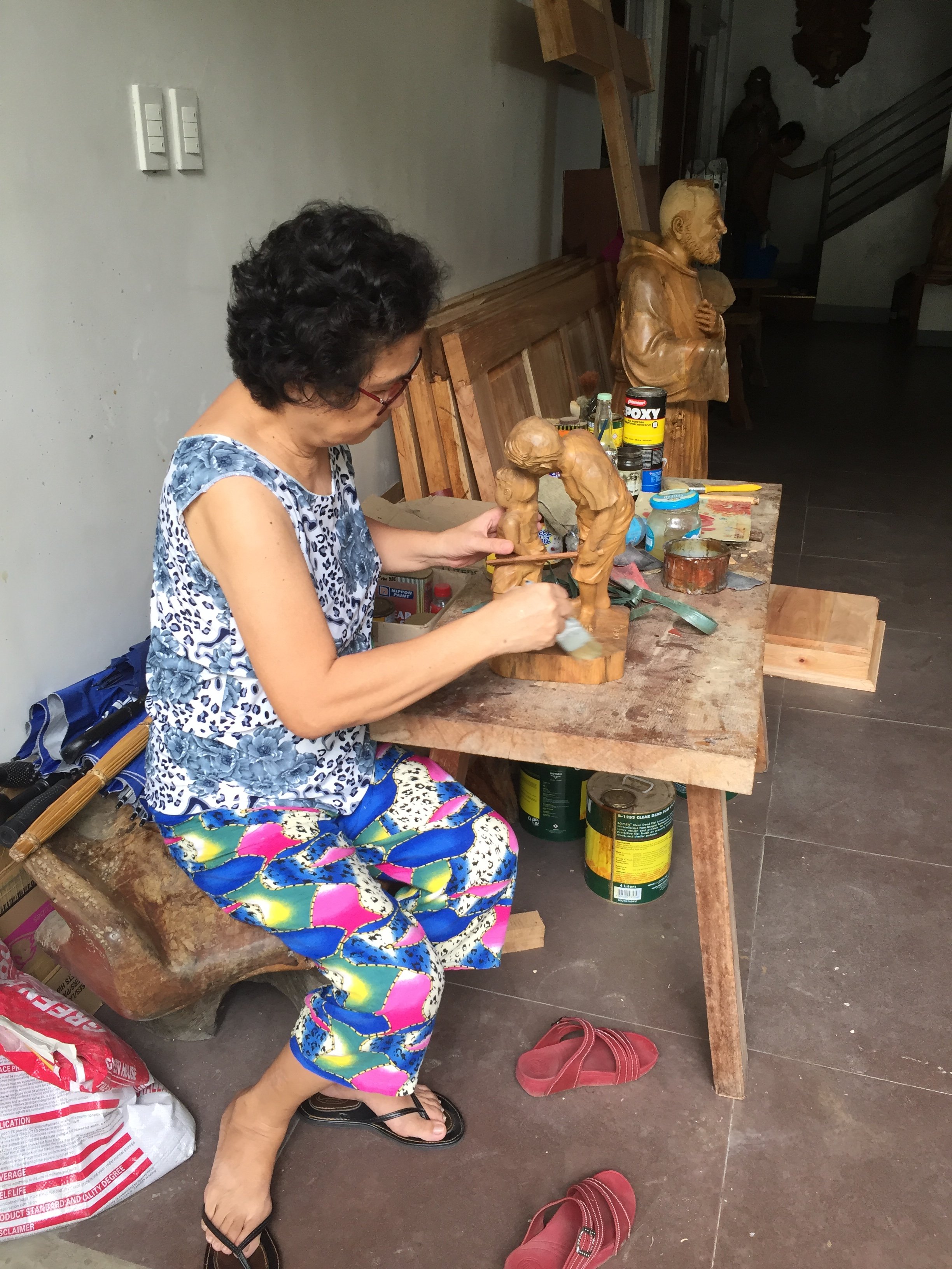 Cely doing as-is on wood carvings of her husband.