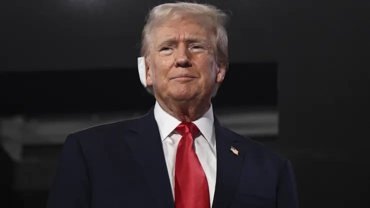 US former President and 2024 Republican presidential candidate Donald Trump, a bandage on his ear after being wounded in an assassination attempt, attends the first day of the 2024 Republican National Convention at the Fiserv Forum in Milwaukee, Wisconsin, July 15, 2024.