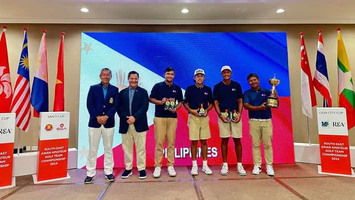 MEMBERS of the national team celebrate after reclaiming the Putra Cup trophy at the Seletar Country Club in Singapore. Shown are (from right) national coach Boyet Zaragosa, Jet Hernandez, Enrique Dimayuga, Carl Corpus and NGAP secretary general Bones Floro with a tournament official from the Singapore Golf Association.