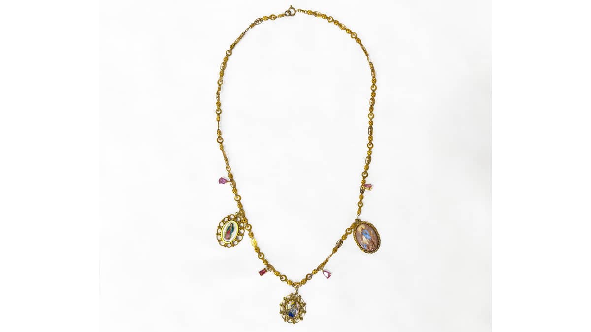 A GARGANTILLA antique necklace with three religious esmalte porcelain medals and four pink tourmaline drops set in yellow gold (left) estimated at P120,000 to P140,000; a pair of ‘Diwa’ earrings which feature diamonds set in 14-karat yellow gold, estimated at P40,000 to P45,000.
