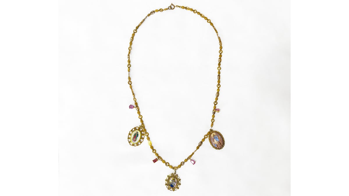A GARGANTILLA antique necklace with three religious esmalte porcelain medals and four pink tourmaline drops set in yellow gold (left) estimated at P120,000 to P140,000; a pair of ‘Diwa’ earrings which feature diamonds set in 14-karat yellow gold, estimated at P40,000 to P45,000.