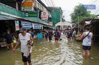 Despite ongoing flooding, customers persevere at the wet and dry market in Karangalan, Cainta, Rizal, wading through the water to purchase goods, 25 July 2024.