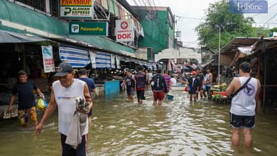 Despite ongoing flooding, customers persevere at the wet and dry market in Karangalan, Cainta, Rizal, wading through the water to purchase goods, 25 July 2024.