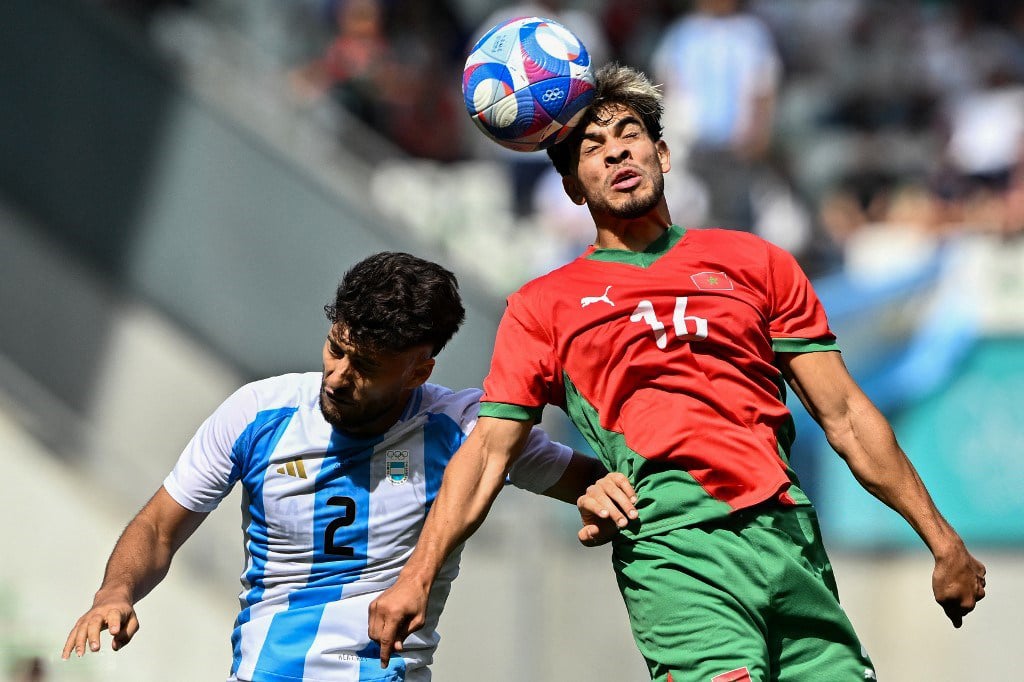 ABDE Ezzalzouli (right) of Morocco goes for a header against the defense of Marco Di Cesare of Argentina during their Group B men’s football match of the Paris Olympics. The Moroccans won, 2-1.