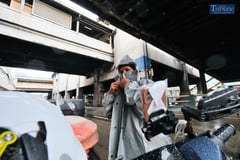 RIDERS SEEK REFUGE UNDER FLYOVER