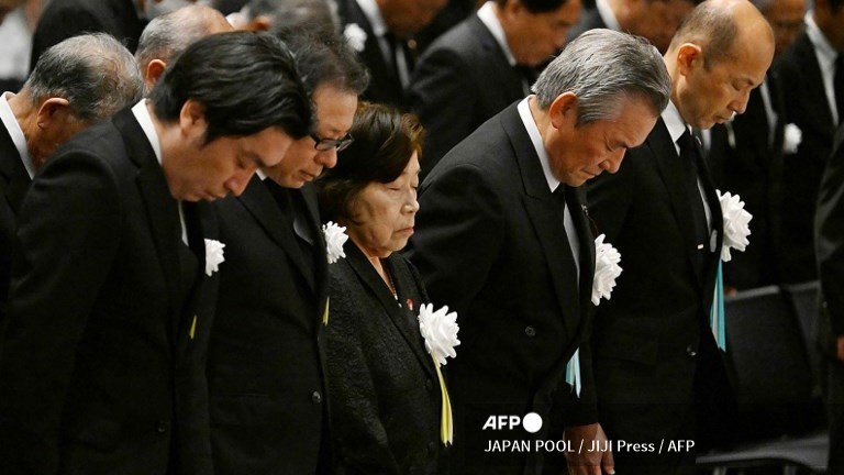 (FILES) Eighty-five-year-old atomic bombing survivor Takeko Kudo (3rd L) and other representatives observe a moment of silence at the time of the bombing at 11:02 am during a peace memorial ceremony at an indoor facility due to approaching Typhoon Khanun in Nagasaki, Nagasaki prefecture on 9 August 2023, as the city marks the 78th anniversary of the atomic bombing during World War II.