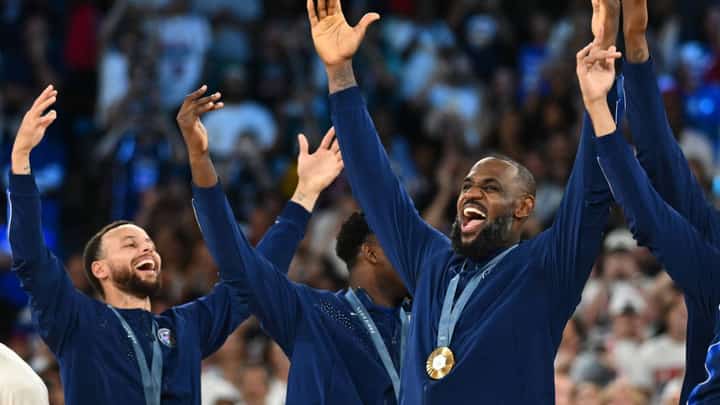 Steph Curry (left) and LeBron James celebrate the United States’ 98-87 victory over France in the Paris Olympics men’s basketball final on Saturday.