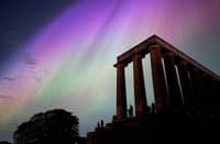 This handout photo taken and released by Jacob Anderson shows the northern lights or aurora borealis during a solar storm over the National Monument of Scotland in Edinburgh on May 10, 2024. The most powerful solar storm in more than two decades struck Earth on May 10, triggering spectacular celestial light shows in skies from Tasmania to Britain — and threatening possible disruptions to satellites and power grids as it persists into the weekend.
