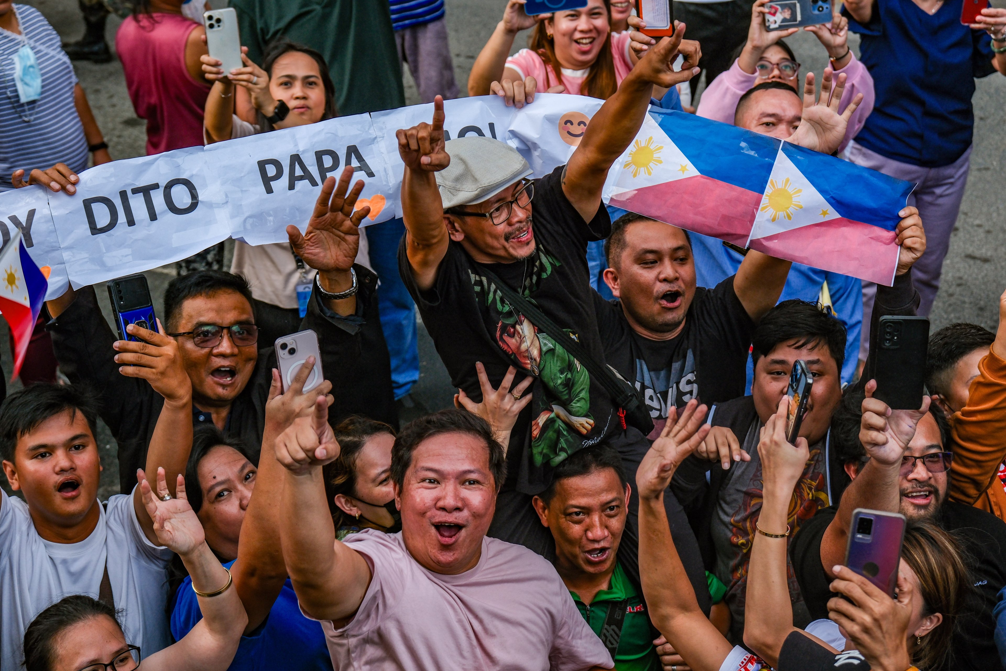 Mark Andrew Yulo (with cap), father of two-time gold medalist, Carlos Yulo, was among the crowds, proud to see his son during the victory parade for the Filipino athletes who participated in Paris Olympics along Roxas Boulevard in Manila on Wednesday.