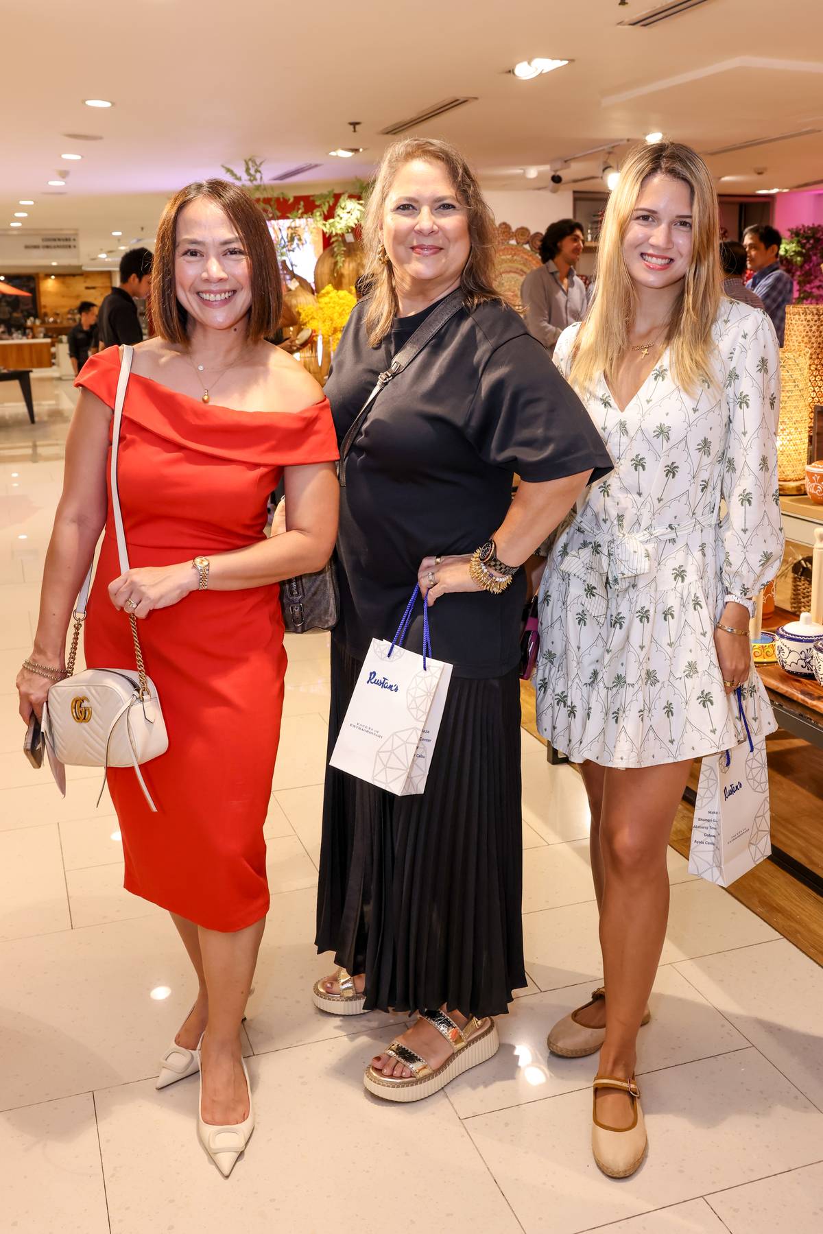 Jackie Avecilla, marketing communications manager of Rustan Commercial Corporation, with Junie and Natalie Peña.