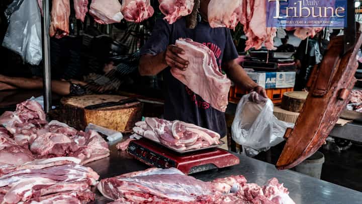 A MEAT vendor chops a pork belly upon order on August 18, 2024. The spread of African Swine Fever (ASF) in the Philippines has led to panic among hog raisers, prompting some to sell infected pigs to traders, further worsening the situation. The Bureau of Animal Industry (BAI) has intercepted several trucks carrying pigs from ASF-hit areas, and the Department of Agriculture (DA) suspects that these traders are a major source of the virus's spread. The government is set to start vaccinating pigs soon to control the outbreak, though concerns remain about the limited availability and effectiveness of vaccines. If the situation deteriorates, the government may consider importing pigs to address potential shortages. PHOTO BY YUMMIE DINGDING
