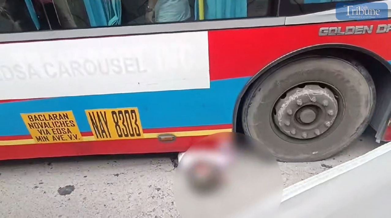QCDRRMO-SAR removes the lifeless body of a motorcycle rider from underneath a passenger bus along North Edsa in Quezon City on Monday, 19 August 2024.
