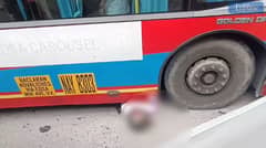 QCDRRMO-SAR removes the lifeless body of a motorcycle rider from underneath a passenger bus along North Edsa in Quezon City on Monday, 19 August 2024.