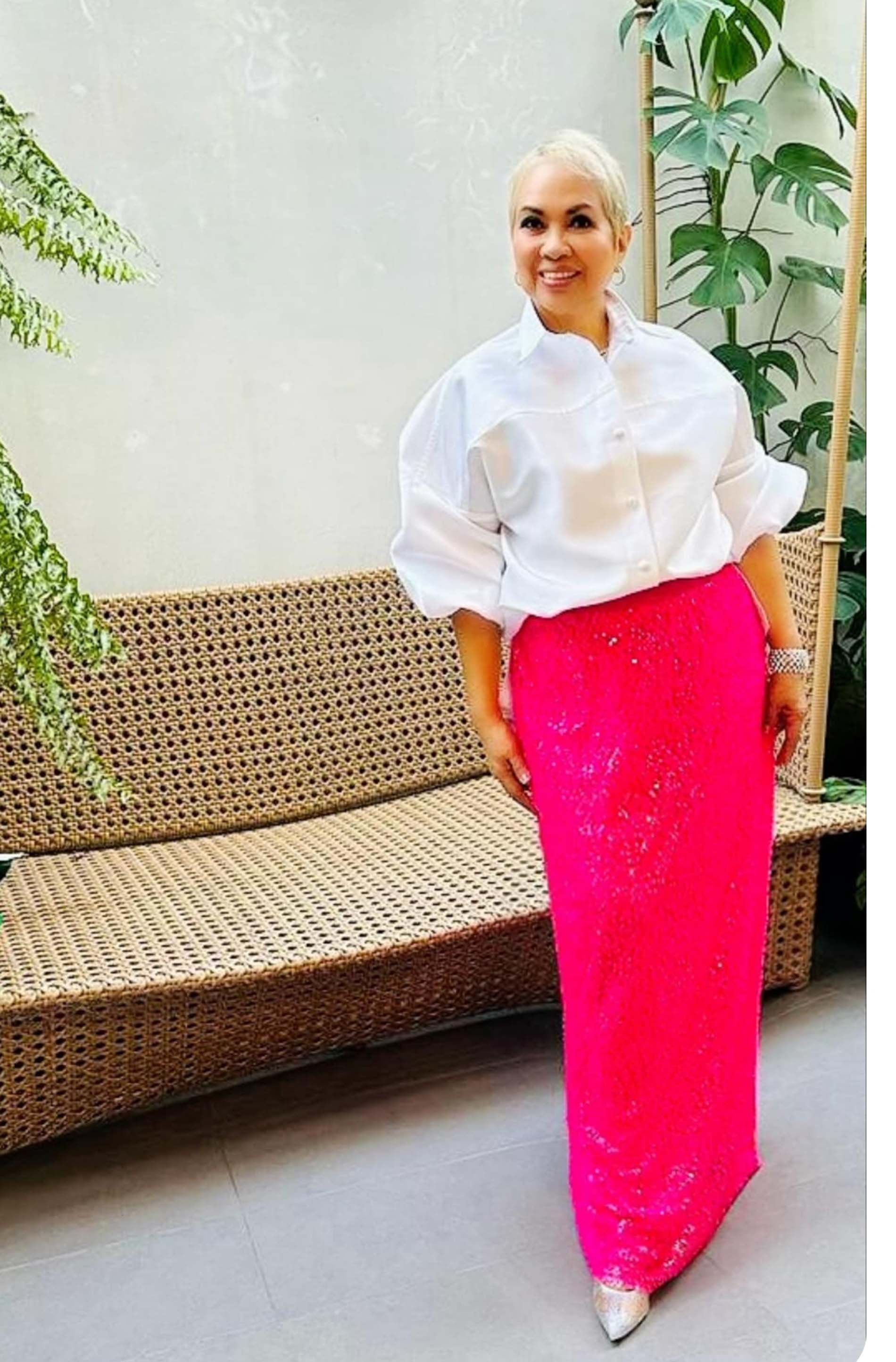 Pinky Chang in oversized button down shirt with hot pink paillette column skirt.