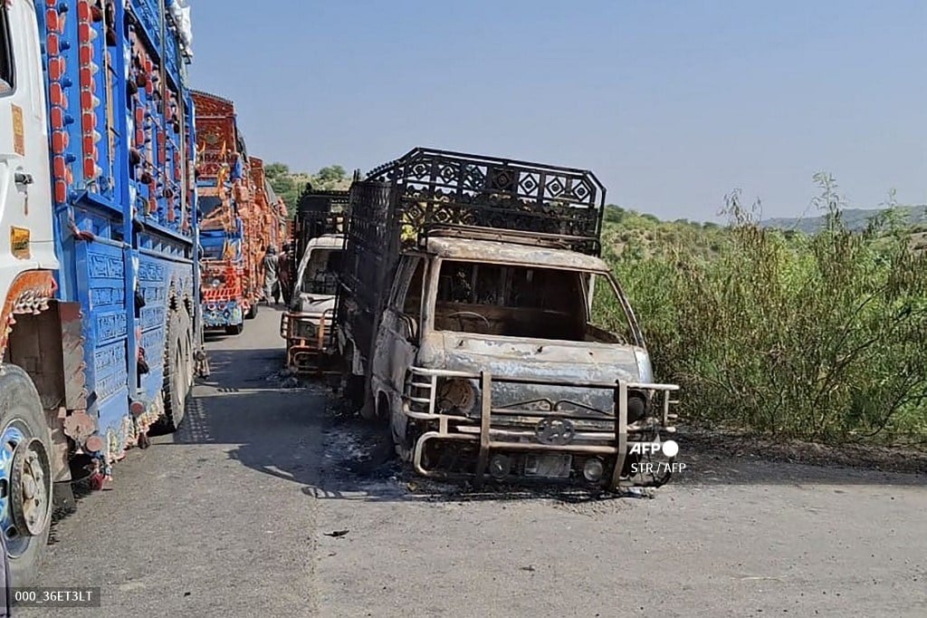 Charred vehicles still billow smoke at the shooting site on the national highway in Musakhail district, Balochistan province. Separatist gunmen shot and killed at least 22 people in southwest Pakistan on 26 August in an attack that singled out ethnic Punjabis, government officials said.