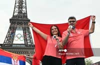 Silver medallists Turkey's Sevval Ilayda Tarhan (L) and Yusuf Dikec from the shooting 10m air pistol mixed team event pose before the Eiffel Tower at the Champions Park at Trocadero during the Paris 2024 Olympic Games in Paris on July 31, 2024.
