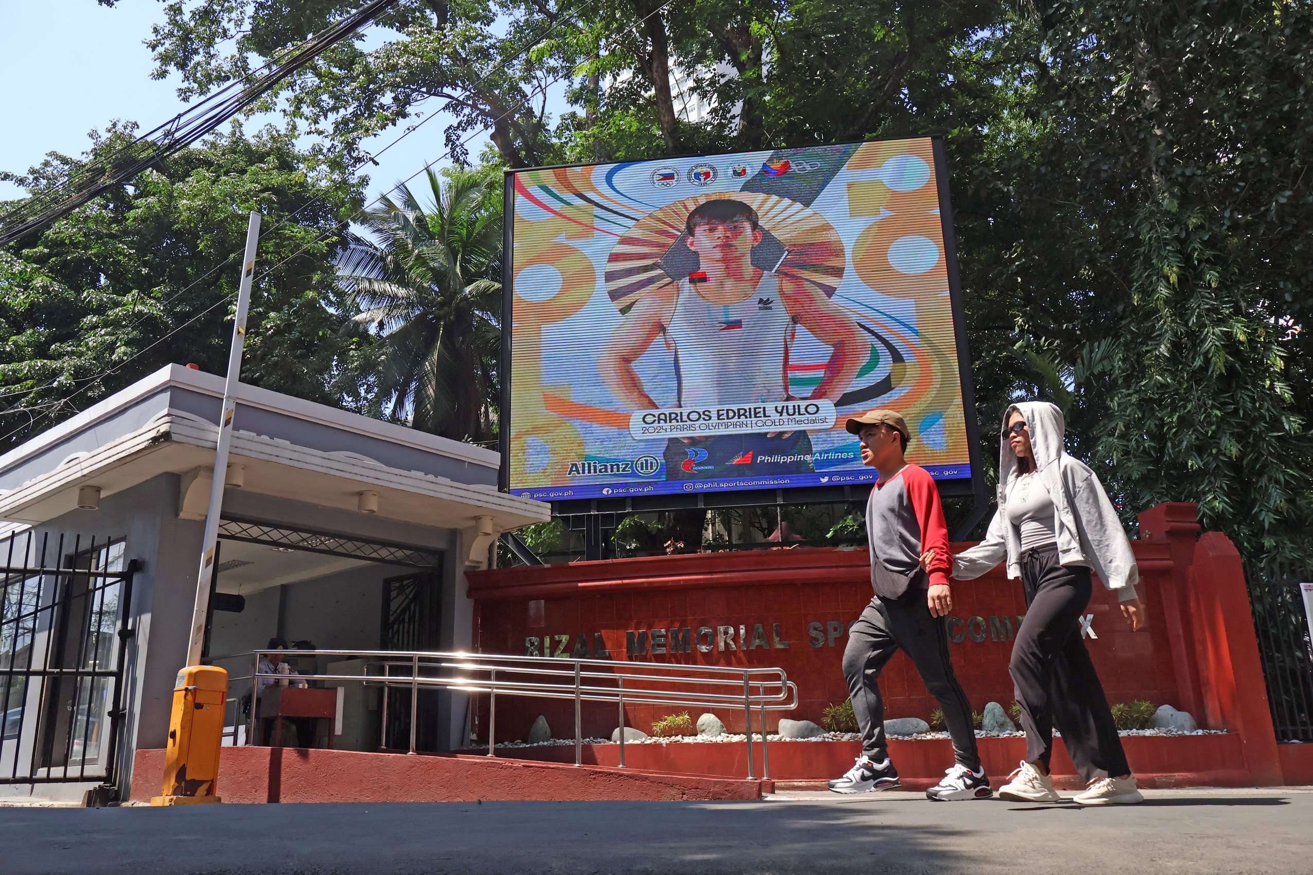 The PSC’s congratulatory message to Paris Olympics gold medalist Carlos Yulo is displayed on the giant screen at the Rizal Memorial Sports Complex main entrance in Malate, Manila.