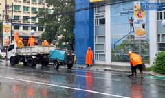 LOOK: Department of Public Works and Highways (DPWH) personnel are busy covering potholes with asphalt amid the downpour brought about by Tropical Storm "Enteng" along Gil Puyat Avenue in Makati City on Monday, 2 September 2024.