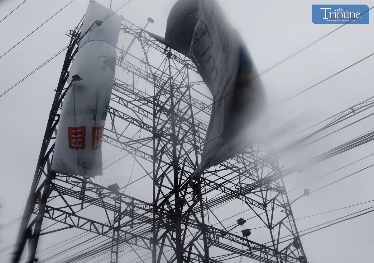 LOOK: On Monday, 2 September 2024, workers battled heavy rain and wind from Tropical Storm "Enteng" while trying to fold a billboard on Edsa, Brgy Kamuning in Quezon City.