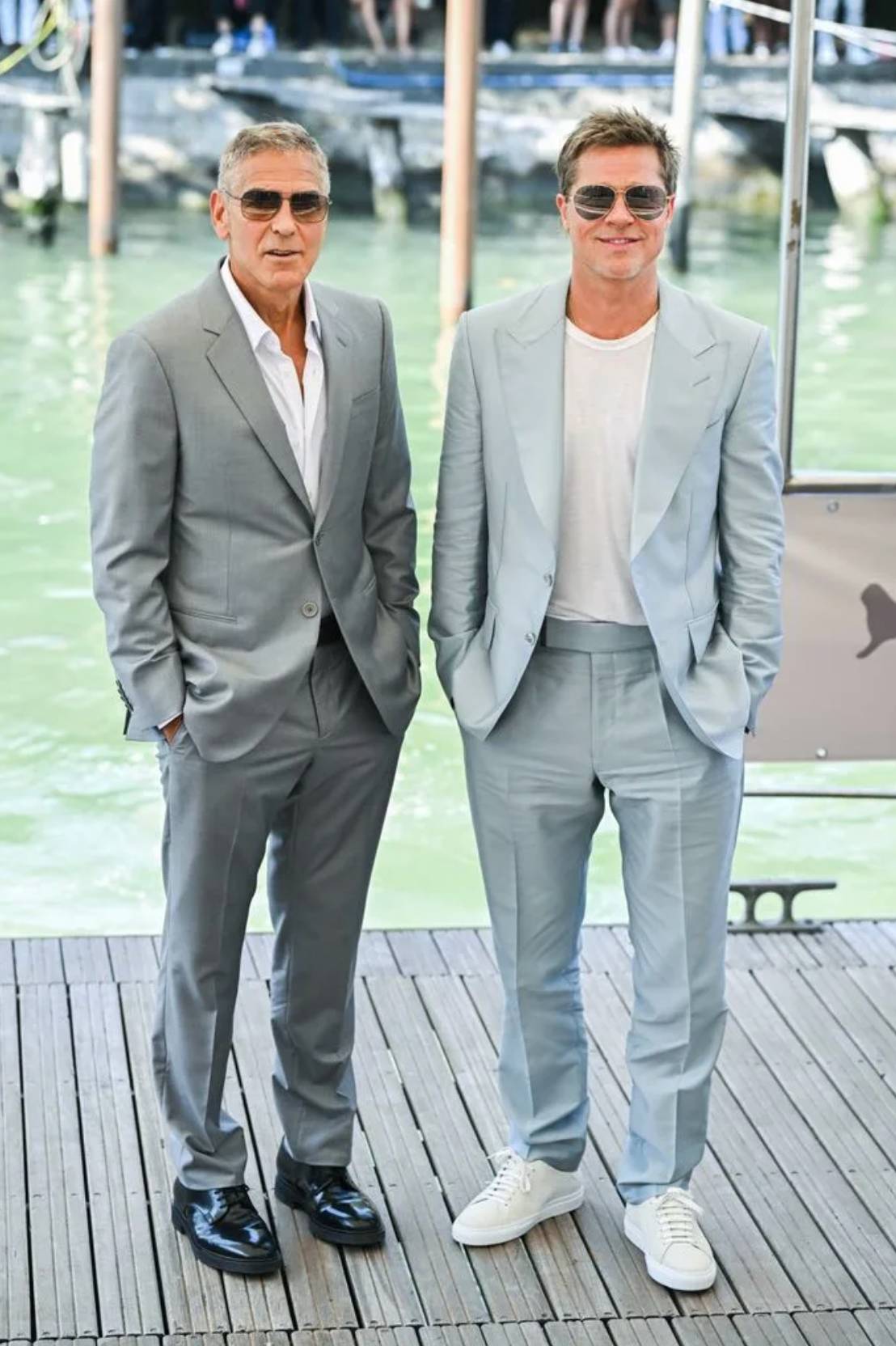George Clooney and Brad Pitt on a pier by the water