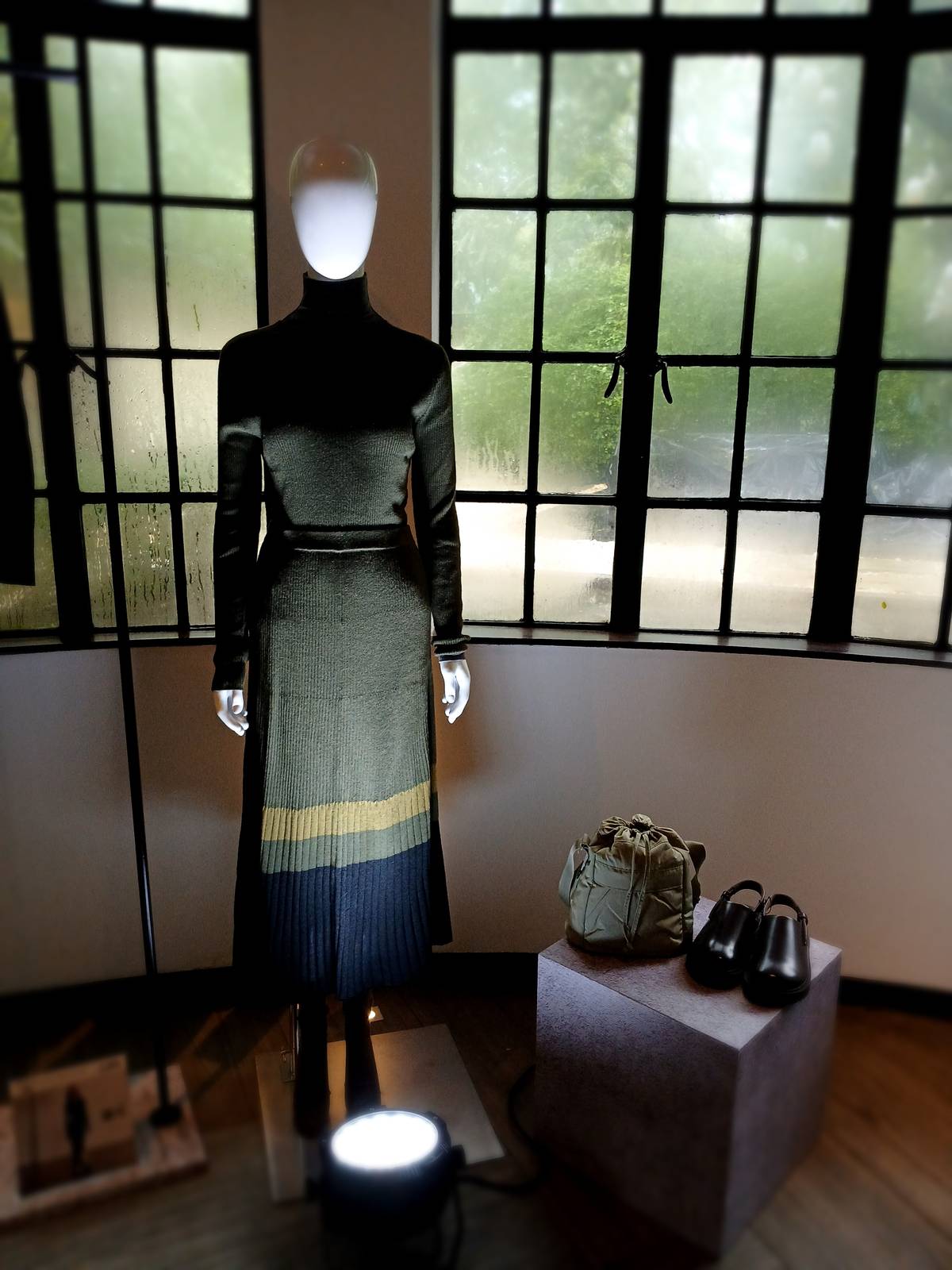 Pair a long bias-cut dress in traditional checks with a slim ribbed merino knit.
